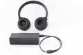 Wireless bluetooth headphones on a white background with a power bank. Royalty Free Stock Photo