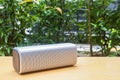 Wireless bluetooth portable speaker on wooden table in home garden