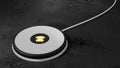 Wireless charging pad in white on black table Royalty Free Stock Photo