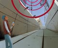 Wireless communication in the city. Gloomy concrete tunnel and teenager with a smartphone