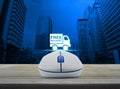 Wireless computer mouse with free delivery truck icon on wooden Royalty Free Stock Photo