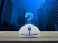 Wireless computer mouse with question mark sign icon on wooden t Royalty Free Stock Photo