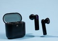 wireless earbuds on a blue background Royalty Free Stock Photo