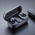 Wireless earbuds with charging case on a dark surface, ready to use. Royalty Free Stock Photo