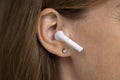 Wireless earphone object in female ear close up Royalty Free Stock Photo