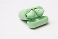 Wireless earphones, light green for listening to sound from mobile phones. Royalty Free Stock Photo