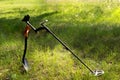 The wireless metal detector is mounted on a shortened metal shovel