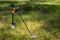 The wireless metal detector is mounted on a shortened metal shovel