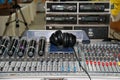 Wireless microphone and headphone put on sound music mixer control panel. Sound Mixer Equalizer Panel Royalty Free Stock Photo