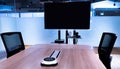Wireless microphone portable on middle meeting table with blank screen television in Video conference meeting room Royalty Free Stock Photo