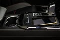 Wireless mobile charger in the modern car. Royalty Free Stock Photo