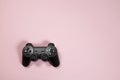 Wireless modern joystick gamepad on pink background, minimalism style. Copyspace for text