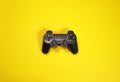 Wireless modern joystick gamepad on yellow background, minimalism style