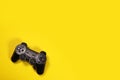 Wireless modern joystick gamepad on yellow background, minimalism style. Copyspace for text