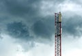 Wireless network tower over dramatic dark sky clouds Royalty Free Stock Photo