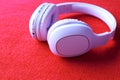 Wireless Pink Headphones, isolated in red fabric background, use for listening music and watch movie or exercise, earphones.