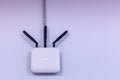 Wireless router for the network hanging on the white wall. World network technologies. Royalty Free Stock Photo