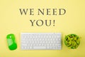 Wireless slim white keyboard and green mouse and text We need you Royalty Free Stock Photo