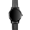 Wireless smart watch in a round shiny black case and black leather strap