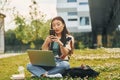 Wireless technologies. Young asian woman is outdoors at daytime