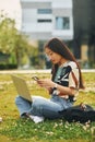 Wireless technologies. Young asian woman is outdoors at daytime