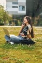 Wireless technologies. Young asian woman is outdoors at daytime