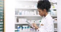 Wireless technologys got her covered. an attractive young pharmacist using a digital tablet in a chemist.