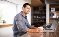 Wireless thinking. a young man contemplating while sitting at his kitchen table with his laptop. Royalty Free Stock Photo