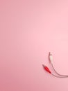 wires with audio input plugs on a pink background