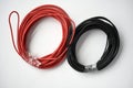 Wires for electronics on a white background. Two coils of red and black wires Royalty Free Stock Photo