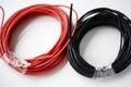 Wires for electronics on a white background. Two coils of red and black wires Royalty Free Stock Photo