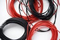 Wires for electronics on a white background. Two coils of red and black wires Royalty Free Stock Photo