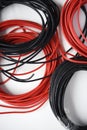 Wires for electronics on a white background. Two coils of red and black wires Royalty Free Stock Photo