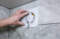 Wires in hands.Man is installing the wall bathroom fan vent. Restor Royalty Free Stock Photo