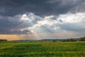 Wisconsin farmland with sunrays coming out of the clouds in September