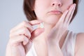 Wisdom tooth extraction, woman suffering from a toothache on gray background