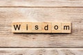 Wisdom word written on wood block. wisdom text on table, concept