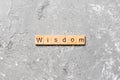 Wisdom word written on wood block. wisdom text on table, concept