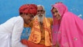 Wise elderly male blessing two young Indian people in traditional clothing Royalty Free Stock Photo