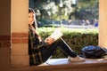 Wise girl with kind eyes sitting at school on the window with th Royalty Free Stock Photo