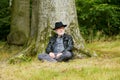 Wise old man sitting under tree in the forest Royalty Free Stock Photo