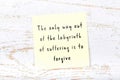 Wise quote on sticky note on wooden wall