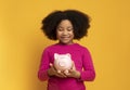 Wise Savings. Adorable Little Afro Girl Holding Piggy Bank In Hands,