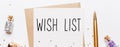 wish list note with envelope gifts and gold glitter stars on white background. merry christmas and New Year concept