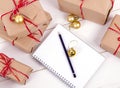 Wish list in to notebook near christmas gifts Royalty Free Stock Photo
