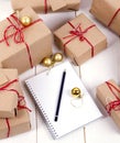 Wish list in to notebook near christmas gifts Royalty Free Stock Photo