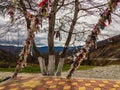 Wish ribbons on the background of trees and mountains.