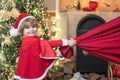 Wish to meet santa claus. Santa boy celebrate christmas at home. Santa Claus kid boy with a bag full of presents. For Royalty Free Stock Photo