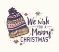 We Wish You A Merry Christmas lettering written with elegant font and decorated by knitted woolen hat and snowflakes