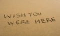 Wish You Were Here written in sand